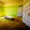 Abandoned and forgotten building and room left by people and being taken over by encroaching sandstorm, Kolmanskop ghost town, Namib Desert